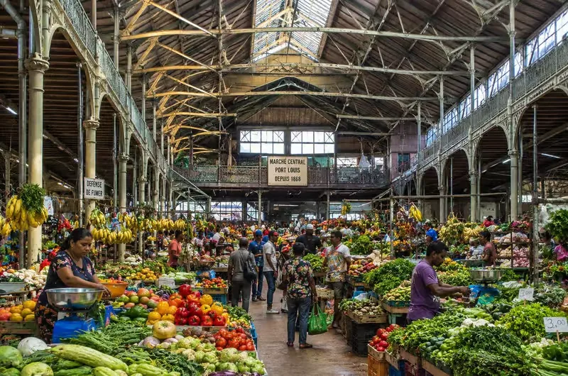 Fruit and vegetable stalls beneath the historic roof of Port Louis Central Market